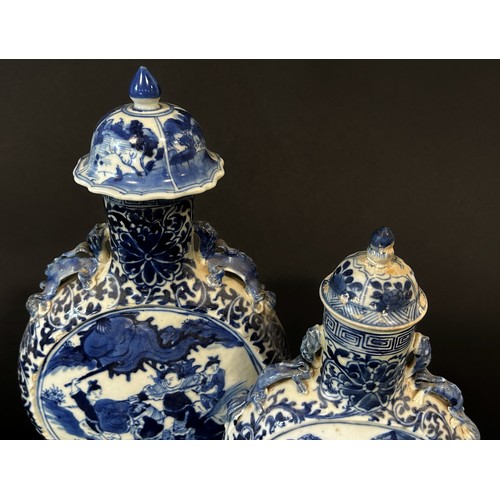 78 - Two Chinese blue and white moon flasks of graduated size, with character and foliate detail, 26cm hi... 