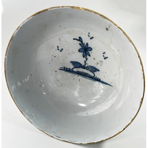 111 - An 18th century Liverpool blue and white Delft bowl, decorated with a Chinese character in landscape... 