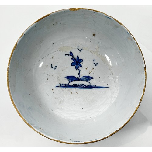 111 - An 18th century Liverpool blue and white Delft bowl, decorated with a Chinese character in landscape... 