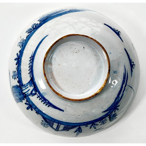 111 - An 18th century Liverpool blue and white Delft bowl, decorated with a Chinese character in landscape... 