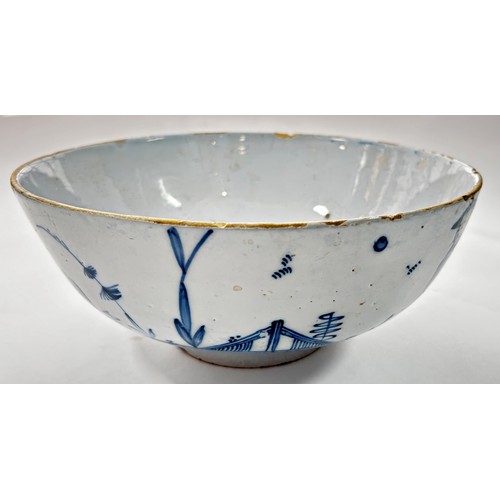 111 - An 18th century Liverpool blue and white Delft bowl, decorated with a Chinese character in landscape... 