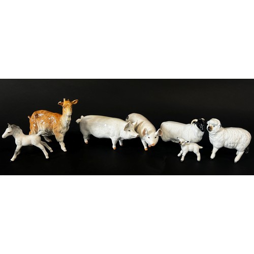 23 - A collection of Beswick and other animals including a pigeon, no.1383, pigs, sheep, goat, etc, toget... 