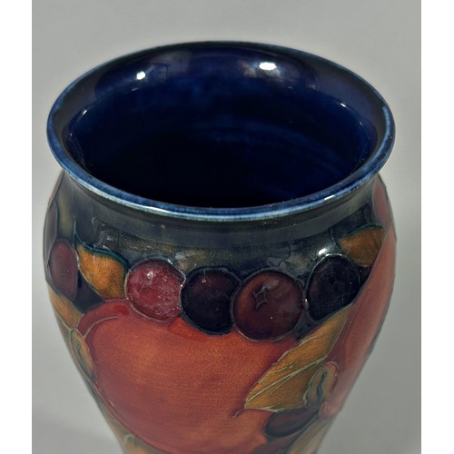 32 - A Moorcroft vase in the Pomegranate pattern, with Moorcroft signature to base, 20cm high