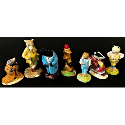 29 - A collection of 13 characters from The Wind in the Willows by Beswick, Royal Albert and Wade potteri... 