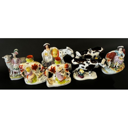 31 - A group of 19th century Staffordshire animal related figures including sheep, cattle and a donkey (7... 