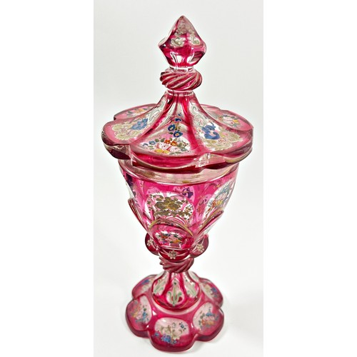 185 - A Bohemian faceted pink glass goblet with hand painted floral decoration, together with a cover, 22c... 