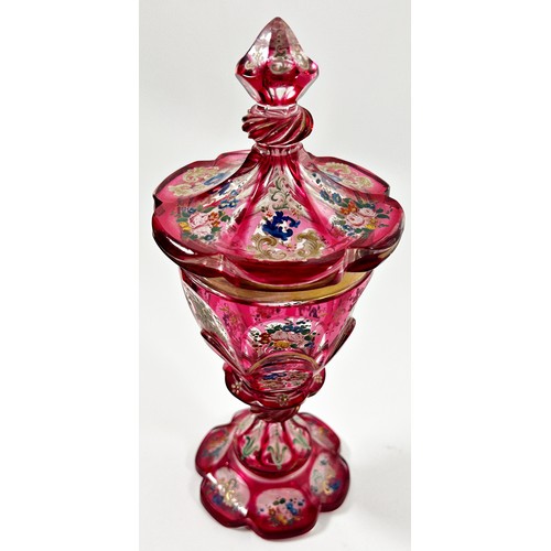 185 - A Bohemian faceted pink glass goblet with hand painted floral decoration, together with a cover, 22c... 