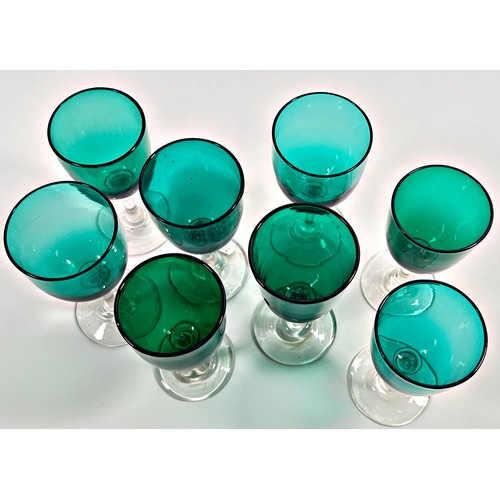 203 - Eight Victorian green glass wine glasses, three at 13.5cm high and five similar at 13cm high.