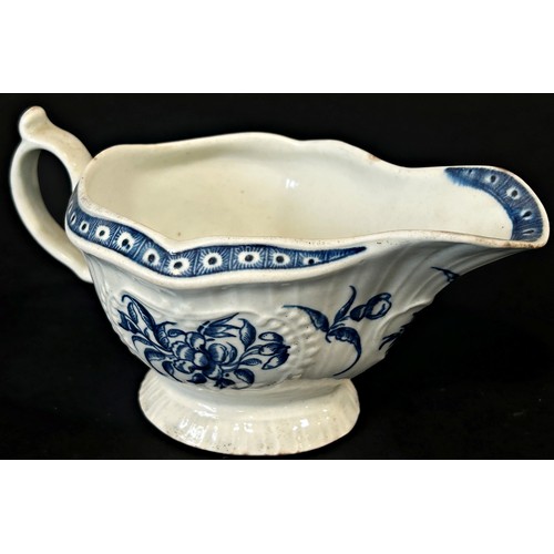 121A - An 18th century Worcester strap fluted sauce boat with floral detail, 16cm long