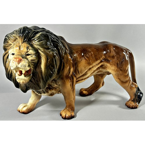 57 - A Melba ware group of three lions; male, female and cub, 40cm long and smaller (3)