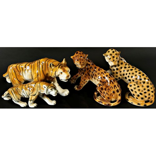 58 - A group of four Royal Dux figures comprising two tigers and two leopards, 415cm long and smaller (4)