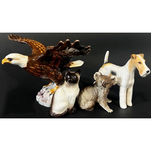 54 - A collection of Beswick ceramic animals and figures to include a large Bald Eagle 1018, with outstre... 