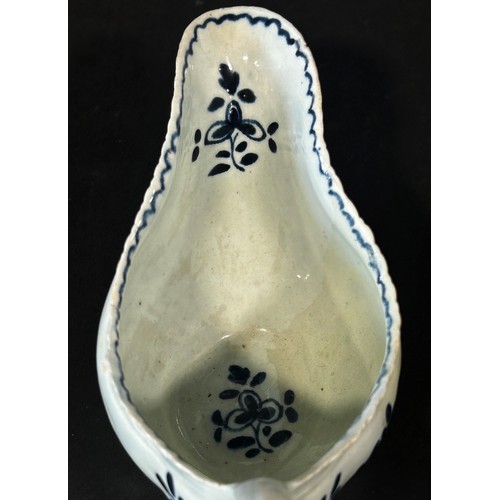 108 - An 18th century Liverpool porcelain sauce boat painted with trailing flowers, 18cm long