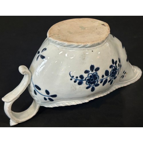 108 - An 18th century Liverpool porcelain sauce boat painted with trailing flowers, 18cm long