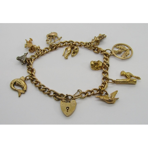 301 - Vintage 9ct charm bracelet with heart padlock clasp, hung with ten novelty charms to include a bull ... 