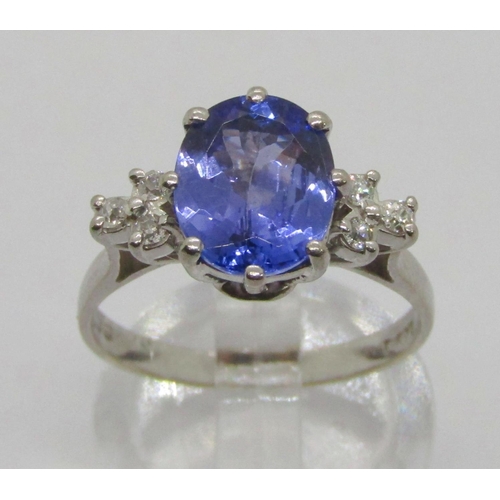 309 - 18ct white gold oval tanzanite and diamond ring with raised setting, maker 'TOD'? (worn), London 197... 