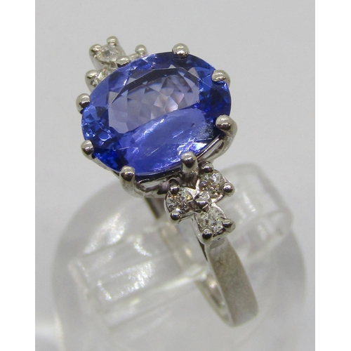 309 - 18ct white gold oval tanzanite and diamond ring with raised setting, maker 'TOD'? (worn), London 197... 