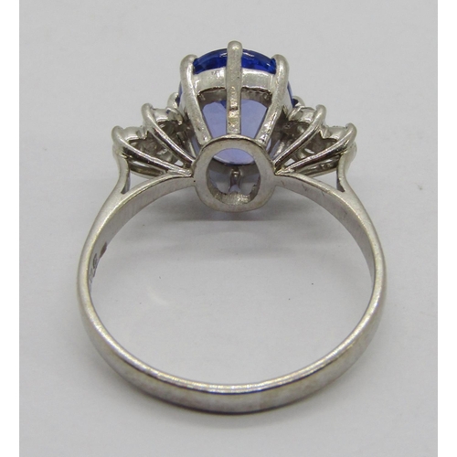 309 - 18ct white gold oval tanzanite and diamond ring with raised setting, maker 'TOD'? (worn), London 197... 