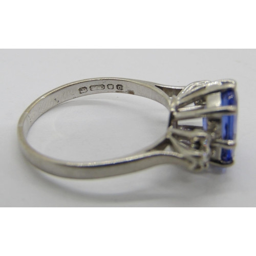 309 - 18ct white gold oval tanzanite and diamond ring with raised setting, maker 'TOD'? (worn), London 197... 