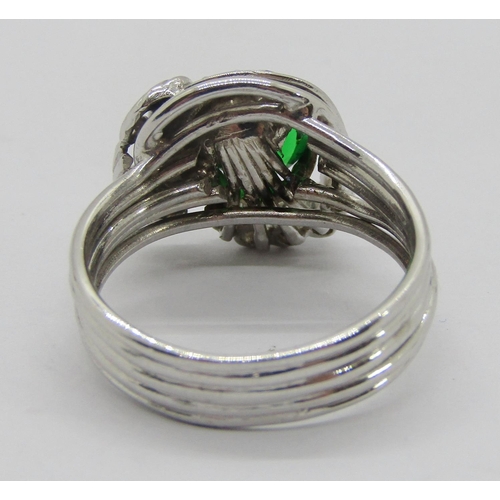 312 - Stylised white metal dress ring set with green paste and diamonds, size M, 7.7g