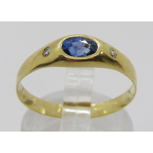 314 - Yellow metal rub-over set sapphire and diamond three stone ring, size P, 1.9g