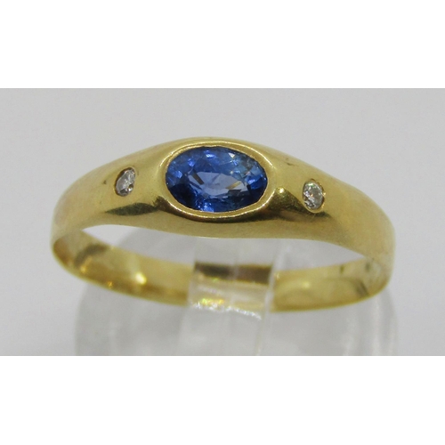 314 - Yellow metal rub-over set sapphire and diamond three stone ring, size P, 1.9g