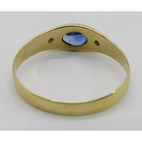 314 - Yellow metal rub-over set sapphire and diamond three stone ring, size P, 1.9g