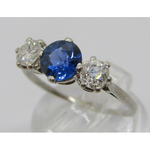 315 - White metal sapphire and diamond three stone ring, sapphire 0.75ct approx, diamonds 0.20ct each appr... 