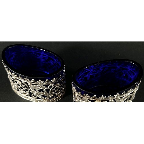 241 - A pair of late Victorian silver salts with straw filigree designs, both with blue glass liners, Birm... 