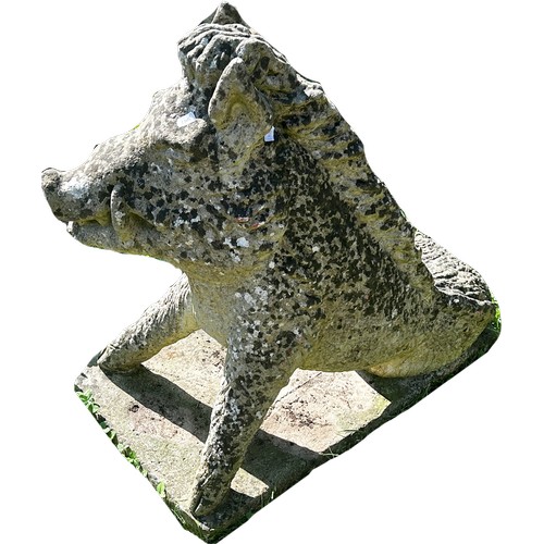 1064 - A well weathered cast composition stone garden ornament/study of a life size seated wild boar set on... 