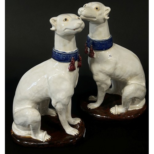 19 - A pair of decorative ornaments in the form of seated hounds, together with  further Staffordshire st... 