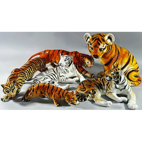 44 - A collection 13 ceramic tigers, various factories, 30cm high and smaller