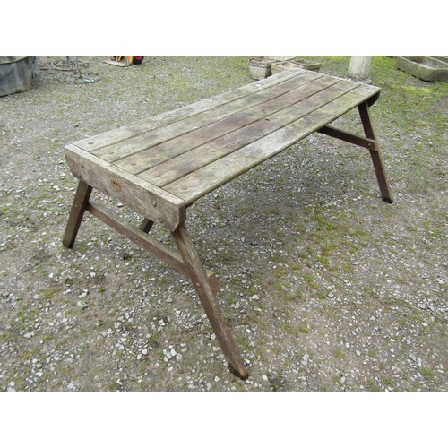 1091 - A weathered Hattersley Keighley teak garden table, the rectangular slatted top raised on splayed 'A'... 