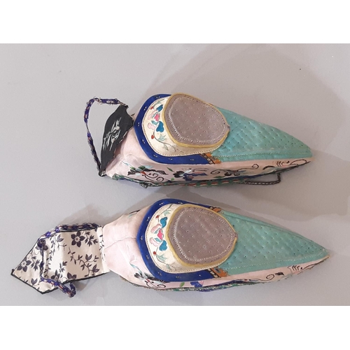 722 - A pair of early 20th century indoor lotus shoes for bound feet with embroidered silk upper and colou... 