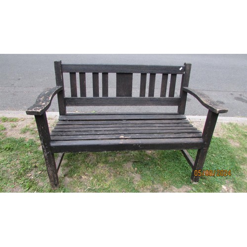 1001 - A stained and weathered teak two seat garden bench with slatted seat and back, 118 cm wide