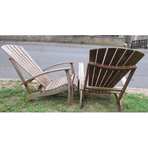 1016 - A pair of weathered heavy gauge hardwood fan back garden open armchairs, in the Art Deco style, with... 