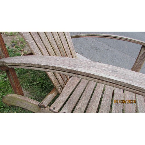 1016 - A pair of weathered heavy gauge hardwood fan back garden open armchairs, in the Art Deco style, with... 