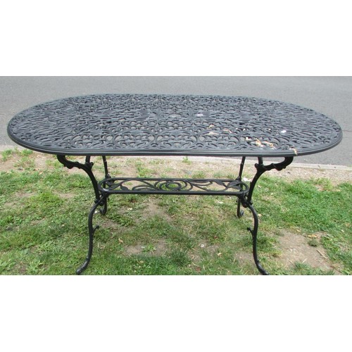 1056 - A mat painted cast aluminium garden terrace table over oval form with decorative pierced and scrolli... 