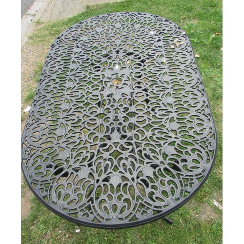 1056 - A mat painted cast aluminium garden terrace table over oval form with decorative pierced and scrolli... 