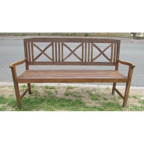 1077 - A contemporary stained hardwood three seat garden bench with slatted seat and back with open x frame... 