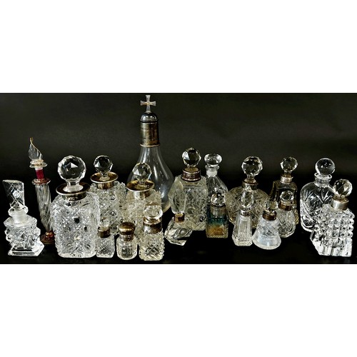 205 - Nineteen late 19th and early 20th cut glass perfume and vanity bottles, some with silver collars and... 