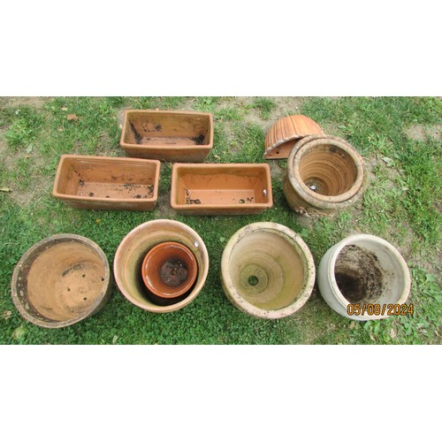 1003 - Ten small weathered terracotta planters of varying design including a couple of examples with relief... 