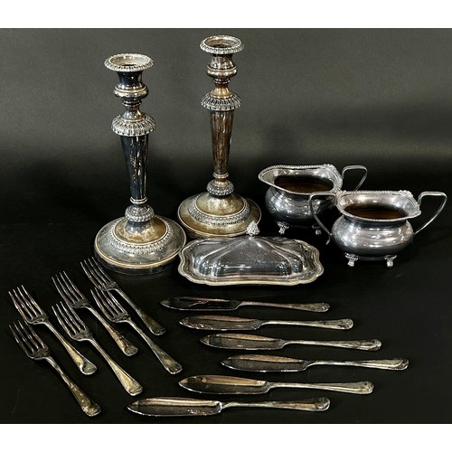 217 - A mixed selection of silver plated table ware, including candlesticks, a claret jug, a four piece te... 