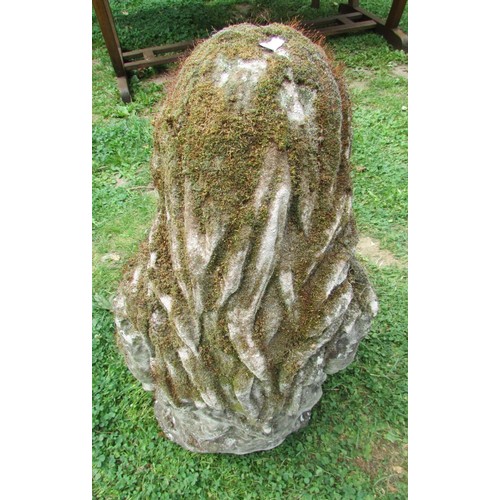 1019 - A well weathered moss encrusted garden ornament in the form of  a girl/young woman in seated pose re... 