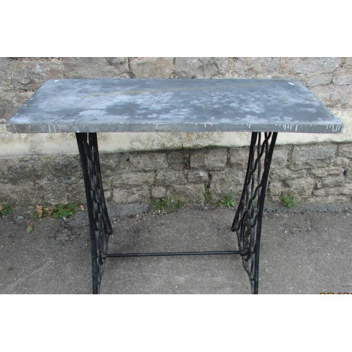 1029 - An old Singer cast iron treadle  sewing machine base, later adapted as a garden table with loose rec... 