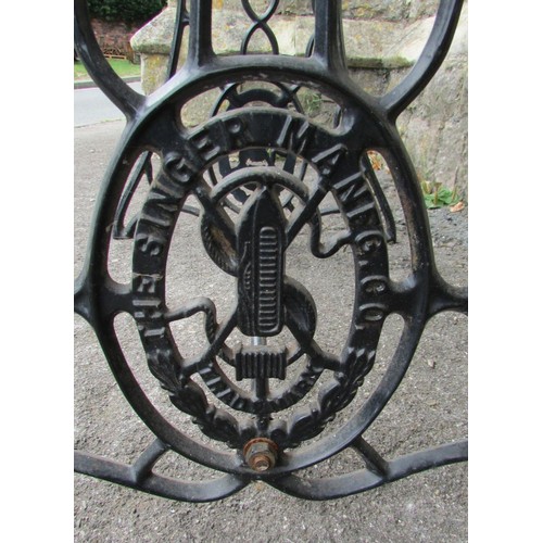 1029 - An old Singer cast iron treadle  sewing machine base, later adapted as a garden table with loose rec... 