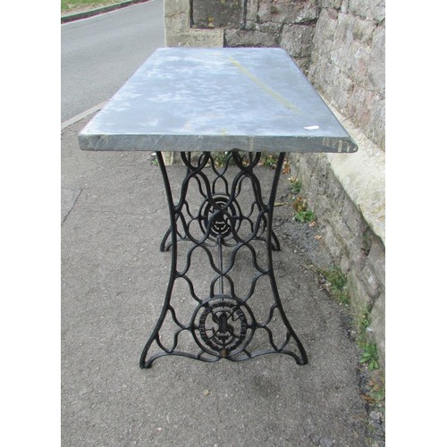 1029 - An old Singer cast iron treadle  sewing machine base, later adapted as a garden table with loose rec... 