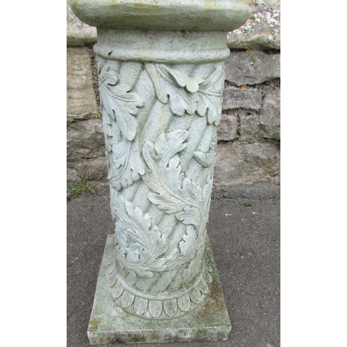 1027 - A weathered cast iron sun dial raised on a composite cylindrical square based pedestal with acanthus... 