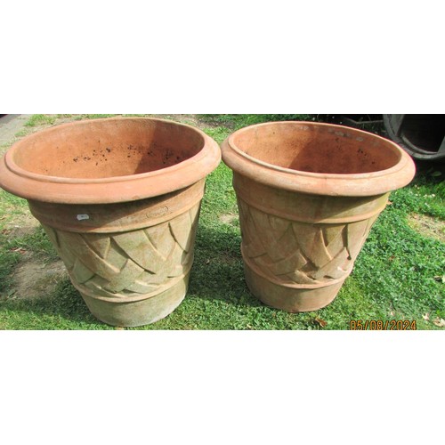 1075 - A pair of terracotta planters of circular tapered form with lattice detail, 58 cm diameter x 54 cm h... 