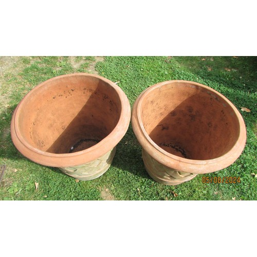 1075 - A pair of terracotta planters of circular tapered form with lattice detail, 58 cm diameter x 54 cm h... 